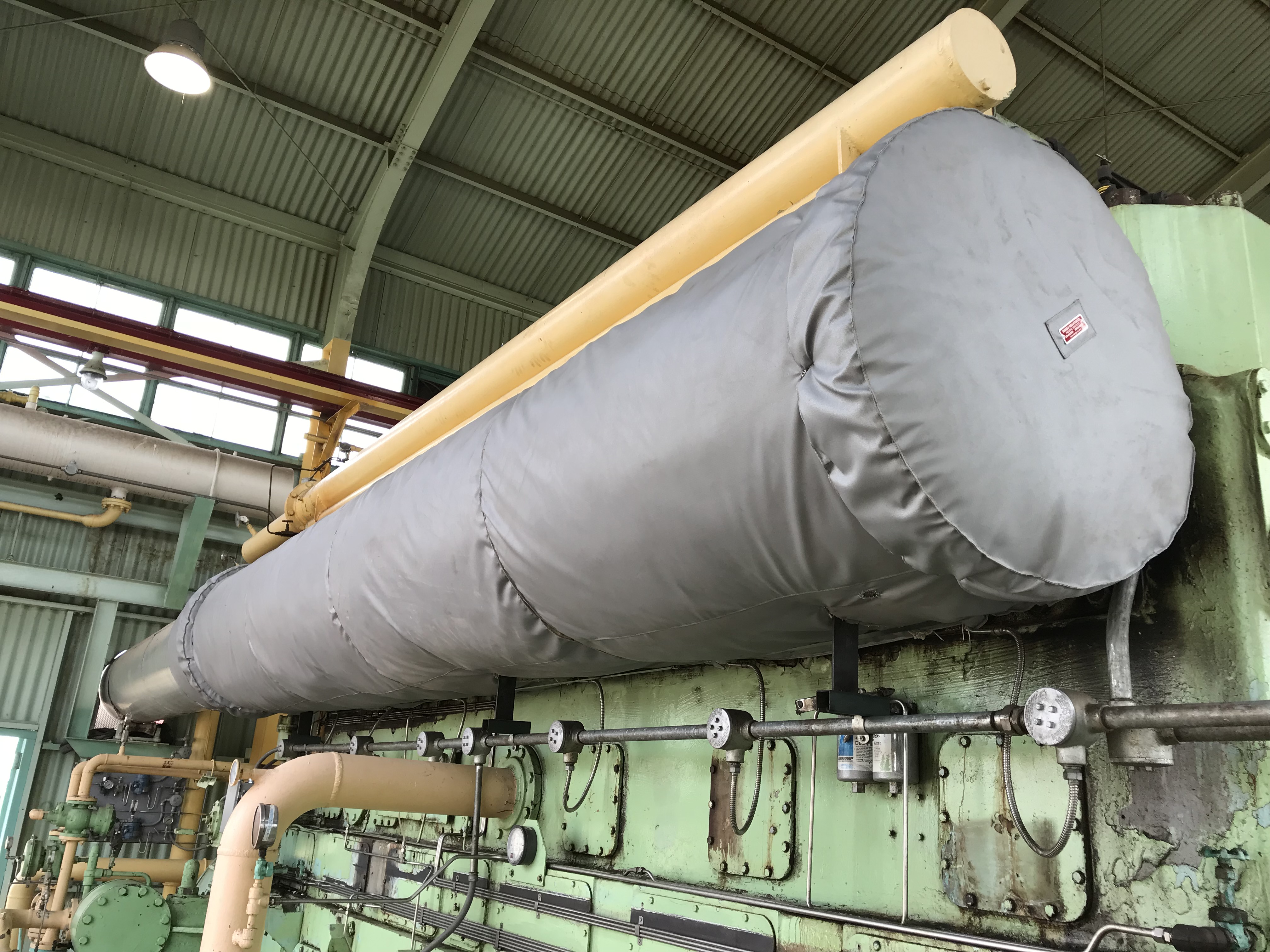 Removable insulation jackets installed on industrial piping